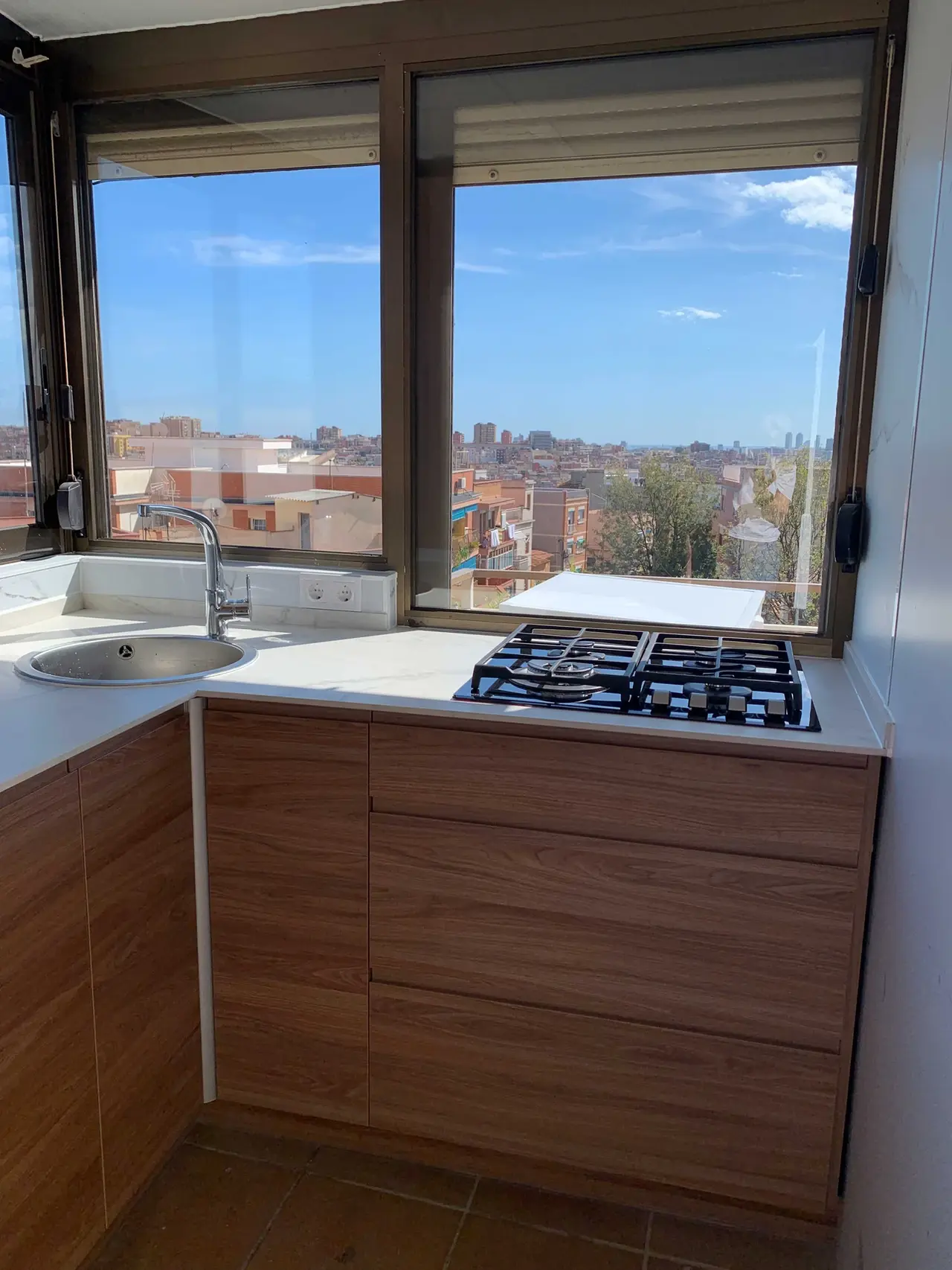Cocina con vistas a la ciudad y muebles de madera