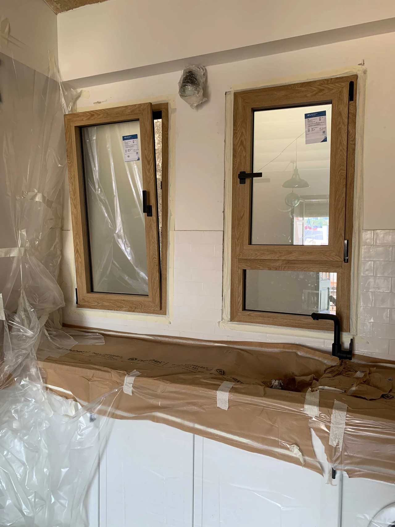 Cocina en reforma con ventanas de madera y protección